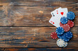 A pile of poker chips and a deck of cards on a wooden table