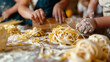 Parents and children making homemade pasta from scratch, rolling out dough and shaping it into noodles