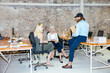 © BONNINSTUDIO/Stocksy - Group of colleagues discussing project in office ugc