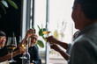 © Studio Firma/Stocksy - Group of people toasting in restaurant