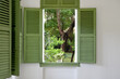 © Jeremiah Le/Stocksy - Relaxing garden view through the green window