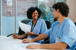 © BONNINSTUDIO/Stocksy - Healthcare workers having a meeting at hospital