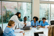 © BONNINSTUDIO/Stocksy - Healthcare workers having a meeting at hospital