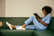 © BONNINSTUDIO/Stocksy - Healthcare worker resting on sofa during break