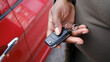 © Jimena Roquero/Stocksy - Crop of hand opening car with remote key