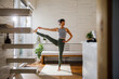 © Jovo Jovanovic/Stocksy - Female balancing on one leg during yoga practice at home