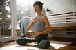 © Jovo Jovanovic/Stocksy - Woman meditating in yoga asana on sunny day