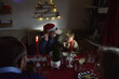 © Anna Malgina/Stocksy - A father and child during Xmas dinner