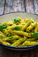 Wall Mural - Penne with basil pesto sauce on wooden table
