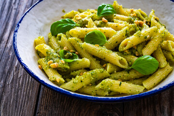 Wall Mural - Penne with basil pesto sauce on wooden table
