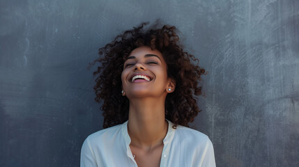 Wall Mural - Happy african-american businesswoman, company leader CEO boss executive standing in front of company building. Portrait of a young black woman isolated on gray wall background.