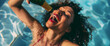 Lifestyle portrait of attractive black woman in a pool pouring champagne into her mouth directly from the bottle, celebrating on a hot summer holiday