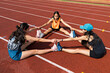 © Moy Ortega/Stocksy - Athletes perform stretching exercises to improve their leg flexibility