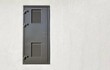 Gray metal door, copy space. Minimalist architecture.