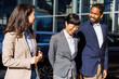 © Jovo Jovanovic/Stocksy - Smiling sales manager discussing with colleagues in car dealership