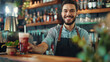 © Muhammad - Happy waiter serving drinks while working in cafe and looking at camera.