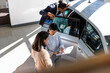 © Jovo Jovanovic/Stocksy - Manager explaining new car details to couple at dealership