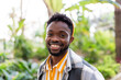 © Raul Navarro/Stocksy - Portrait of happy african american man smiling at camera