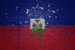 painted big national flag of haiti on a massive old brick wall