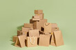 © Marc Tran/Stocksy - Packaging different paper box for courier service on green background