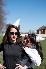 Wall Mural - Portrait of a two young women in sunglasses and hats for a birthday party	