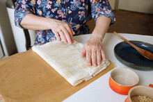 A Woman's Hands Cooking A Pie In A Cozy And Bright Kitchen At Home