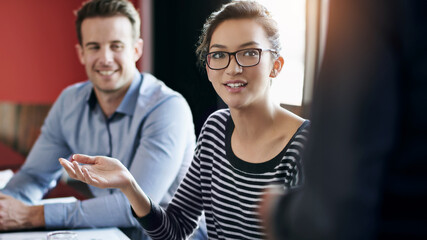 Wall Mural - Business, leader and woman in meeting, talking and discussion with colleagues, teamwork and corporate. Workforce, collaboration and female person giving suggestion on project, copywriter and employee