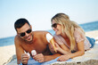 © peopleimages.com - Couple, ice cream and beach for relax and travel outdoor for relationship and dating. Boyfriend, girlfriend or tourist with gelato dessert and smile by ocean for rest on towel in summer for holiday