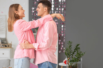 Canvas Print - Young couple in love hugging at home on Valentine's Day