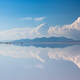 Fototapeta Londyn - Scenery of a salt desert reflecting the blue sky
