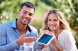 © peopleimages.com - Happy couple, portrait and show tablet in garden for internet, advertising and communication. Man, female person and outdoors at home for mobile, meme and social media scrolling for online platform.