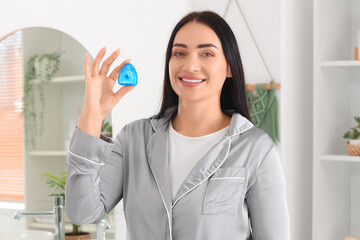 Sticker - Beautiful young happy woman with dental floss in bathroom at home