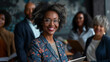 Portrait of beautiful african american businesswoman in eyeglasses holding digital tablet with colleagues in background