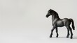 Small, detailed, black toy horse standing isolated on white background with ample copy space