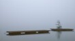 Abandoned bathing jetty early in the morning when the fog is dense