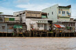 © Mauro Grigollo/Stocksy - Houses along the Mekong river in Vietnam