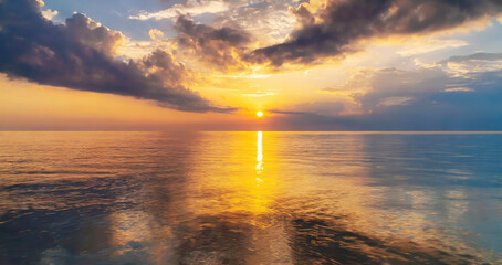 Poster - the sun is setting over the ocean, casting a warm glow on the water. the sky is filled with clouds, 
