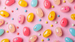 pastel colored jelly bean candies with small sugar decorations on a pink background
