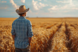 Fototapeta  - A farmer surveying the distant fields, contemplating the upcoming harvest season. Concept of agriculture and sustenance. Generative Ai.