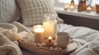 Winter homely scene, scandinavian style. Warm knit sweater, with blank screen, candles, cup of sweet cocoa with marshmallows