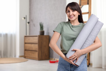 Poster - Young woman with wallpaper rolls at home