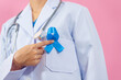 Prostate cancer awareness. Close up medical doctor holding ribbon over pink background isolated. oncology, prostate cancer awareness month, world diabetes day.