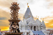Scenic hindu statue with Akshardham Mahamandir temple in the back at BAPS Swaminarayan Akshardham