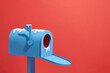 © Marc Tran/Stocksy - Open a blue letter box isolated on red in snow