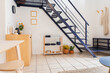 © Shava Cueva/Stocksy - Beautiful apartment with stairs on the first floor and decorations