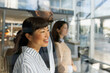 © Jovo Jovanovic/Stocksy - Smiling asian businesswoman standing with colleagues at office