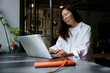 © AD Astra Team/Stocksy - Business woman works with a laptop in a cafe