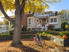 House Exterior Door In Autumn With  Bike Pair In Fall Foliage 