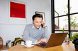 © ALTO IMAGES/Stocksy - Focused male entrepreneur talking on phone during work