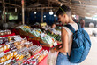 © Alvaro Lavin/Stocksy - Woman at street food market.
